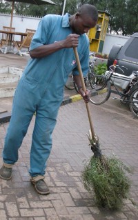 Kenyan man with Kenyan broom
